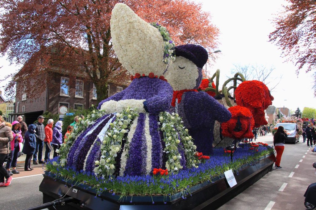Flower Parade float of a Dutch woman in traditional dress made of hyacinths and tulips